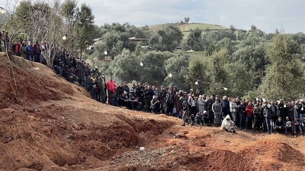 Bystanders watch as Moroccan authorities and firefighters work to rescue five-year-old Rayan