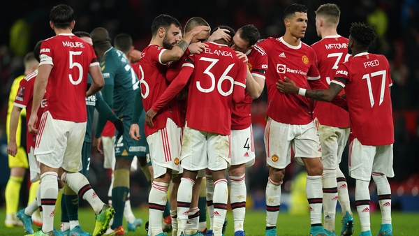 Manchester United's Anthony Elanga is consoled by team-mates after his penalty miss