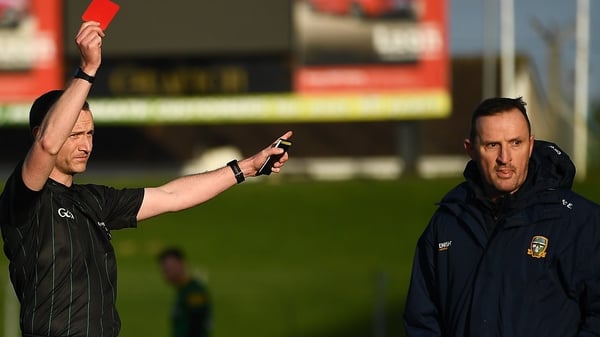 Referee Jerome Henry shows a red card to Meath manager Andy McEntee