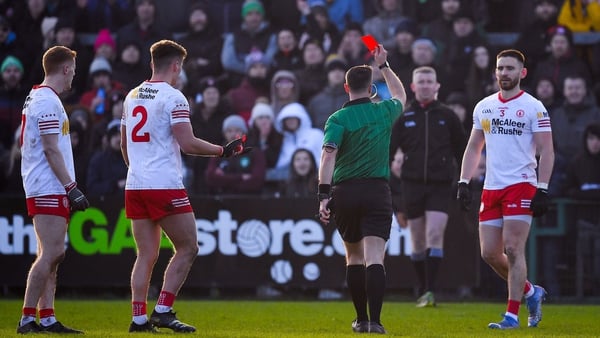 Referee David Gough shows a red card to Tyrone players, from left, Peter Harte, Michael McKernan and Padraig Hampsey.