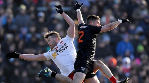 Cormac Munroe of Tyrone and Armagh's Greg McCabe contest a kick-out.