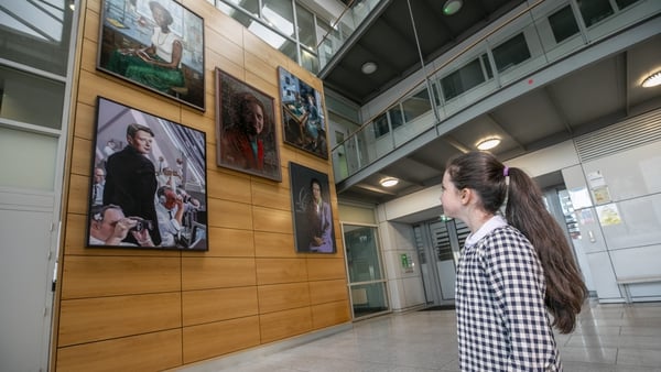 Olivia Brady looking at the portraits commissioned as part of Women on Walls at DCU