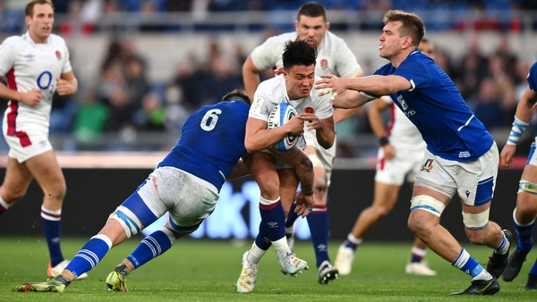 Marcus Smith of England is tackled by Abraham Steyn and Federico Ruzza of Italy