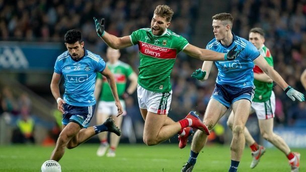 Mayo's Aidan O'Shea goes flying under pressure from Dublin duo Cian O'Sullivan and Brian Fenton during the 2019 league clash between the sides