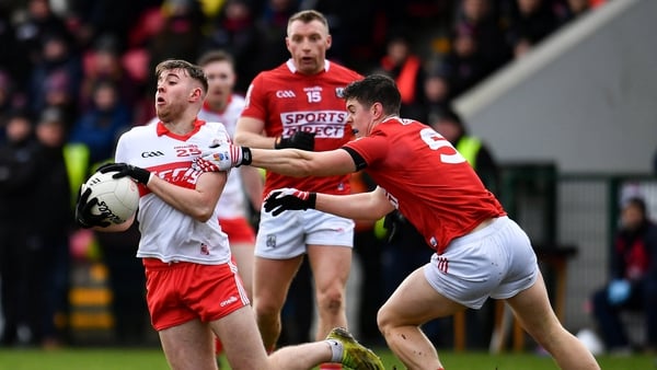 Oisin McWilliams (L) of Derry in action against Rory Maguire of Cork