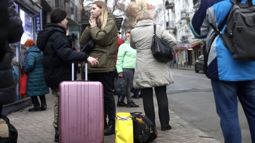 Residents with their belongings wait for pubic transport in Kyiv in Ukraine today