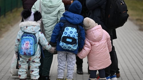 A family fleeing the invasion arrive at the Polish-Ukrainian border in Medyka, southeastern Poland