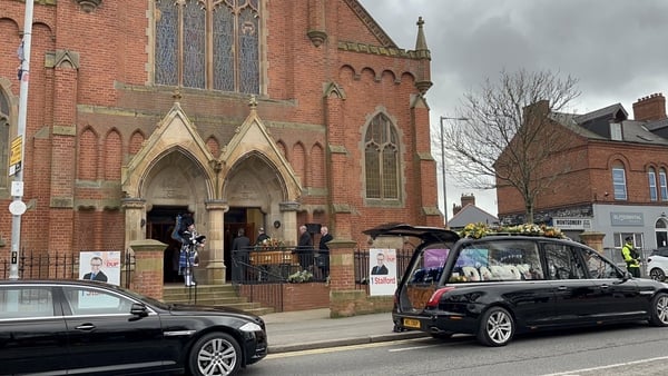 The remains of Christopher Stalford are piped into Ravenhill Presbyterian Church, Belfast.