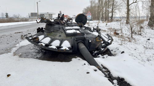 A fragment of a destroyed Russian tank is seen on the roadside on the outskirts of Kharkiv on 26 February