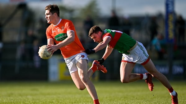 Jarly Og Burns of Armagh is tackled by Fionn McDonagh