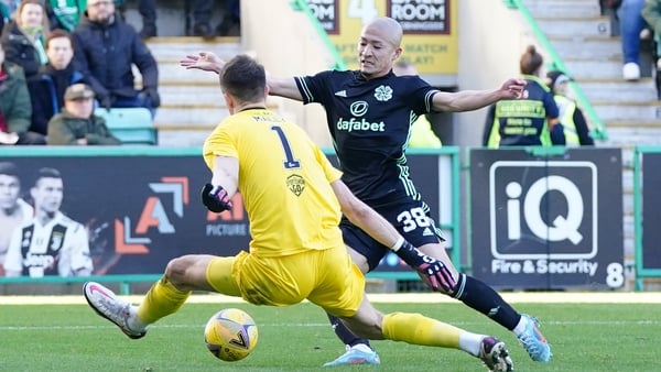 Celtic's Daizen Maeda tries to round Hibernian goalkeeper Matt Macey