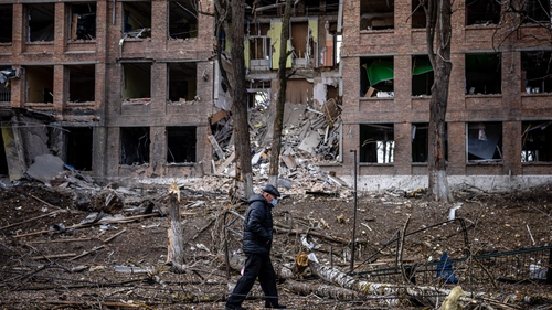 A man walks in front of a destroyed building after a Russian missile attack in the town of Vasylkiv, near Kyiv, on 27 February