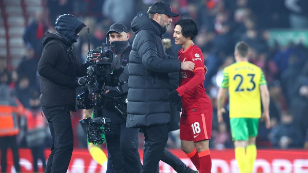 Jurgen Klopp (L) embraces Takumi Minamino after Liverpool's win over Norwich