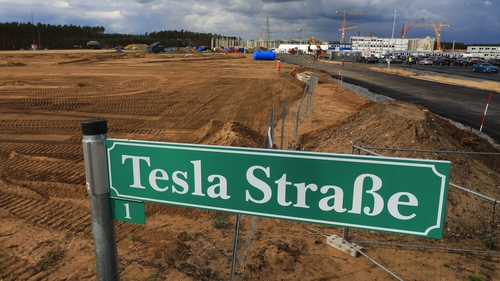 A 'Tesla Street' sign stands near a plot of land at the Tesla gigafactory construction site in Gruenheide in Germany