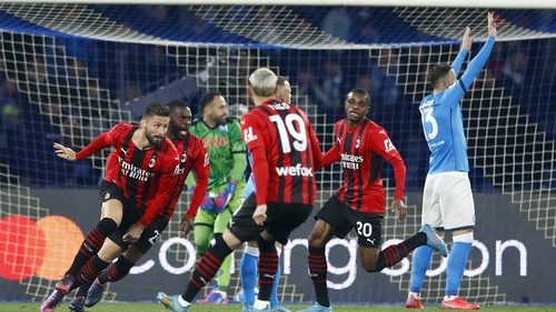 Olivier Giroud (L) of AC Milan celebrates after scoring against Napoli