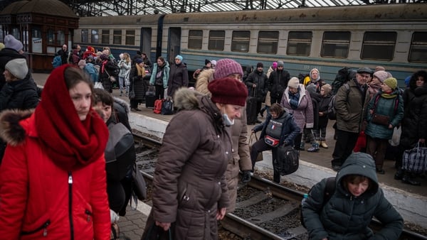 Thousands of people continue to arrive at the train station in Lviv, Ukraine, to leave the country