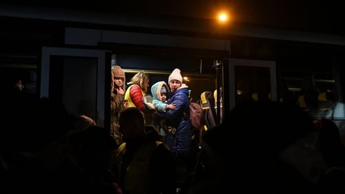 A woman holds her child as she stands in a bus transporting Ukrainian refugees to Przemysl in eastern Poland. Photo: Getty Images