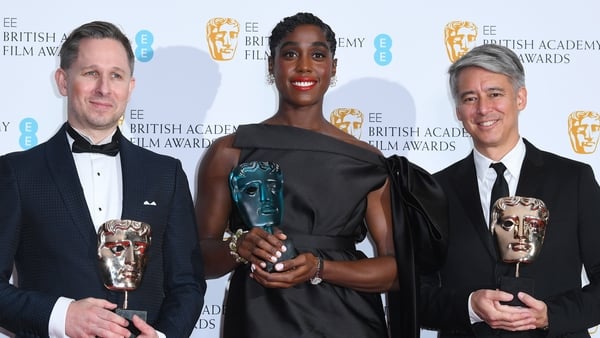L-R Lashana Lynch, winner of the Rising Star award, and Elliot Graham and Tom Cross, winners of the Best Editing award for No Time To Die
