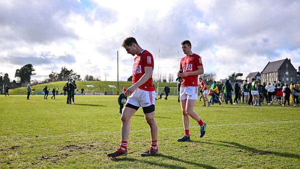 Cork players Cian Kiely, left, and Joe Grimes leave the pitch after defeat to Meath at Pairc Tailteann