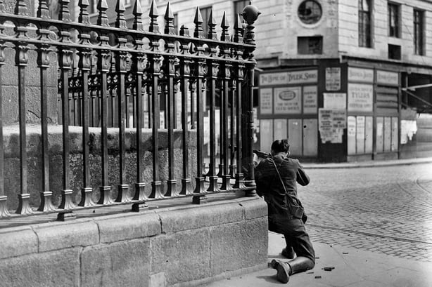 Black and white photo of sniper at the foot of Nelson's Pillar