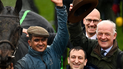 Groom Imran Haider, left, owner Tony Bloom and trainer Willie Mullins, right, celebrate after winning the Betway Queen Mother Champion Chase with Energumene on day two of the Cheltenham Racing Festival