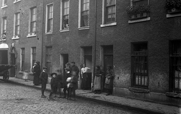 People standing outside a Dublin tenement Photo: Dublin City Library and Archive
