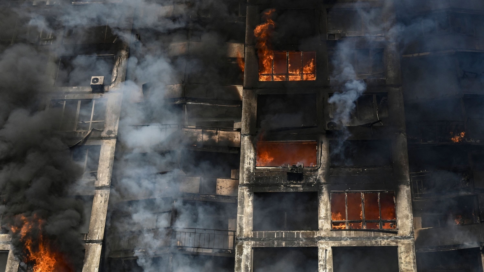 Image - Firefighters extinguish a fire in an apartment building in Kyiv after strikes on residential areas