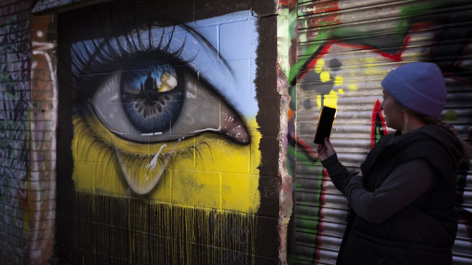 Image - Graffiti artwork in Wales shows a weeping eye in the colours of a Ukrainian flag