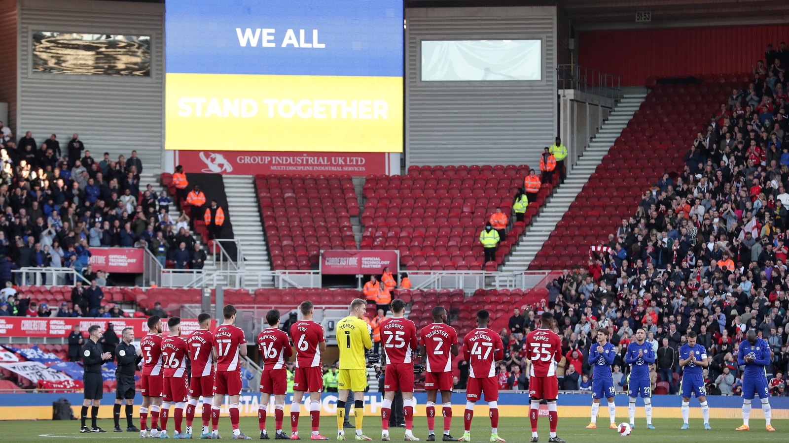 Image - Chelsea and Middlesborough players applaud in support of Ukraine before a match