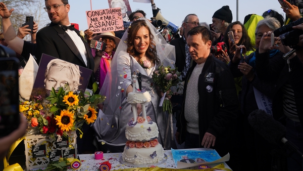 Stella Moris cuts a wedding cake outside Belmarsh prison after her wedding ceremony inside the jail to Julian Assange