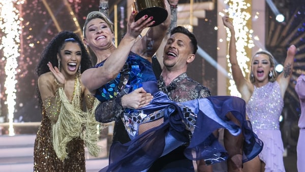 Pasquale holds Nina aloft after their DWTS win