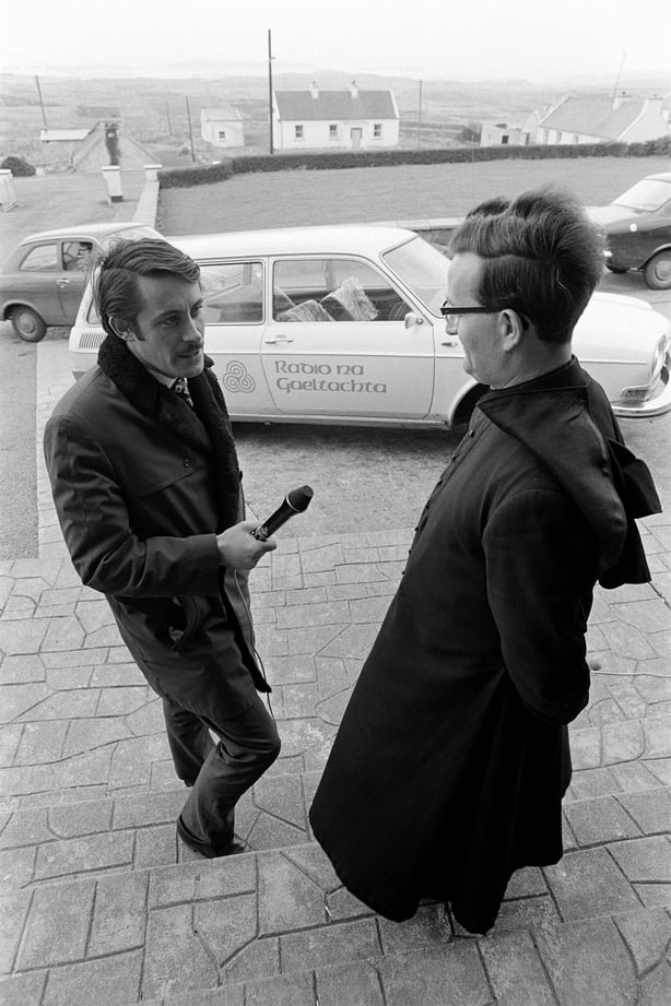 RTÉ Raidió na Gaeltachta broadcaster Feardorcha Ó Colla interviews an t-Athair Dónal Mac Suibhne, the headmaster of Ardscoil Naomh Mhuire in Na Doirí Beaga, County Donegal, in March 1972. Note the Raidió na Gaeltachta car in the background.