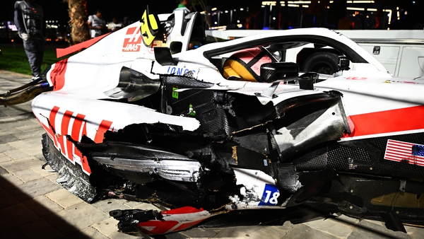 The wrecked car of Mick Schumacher at the side of the track