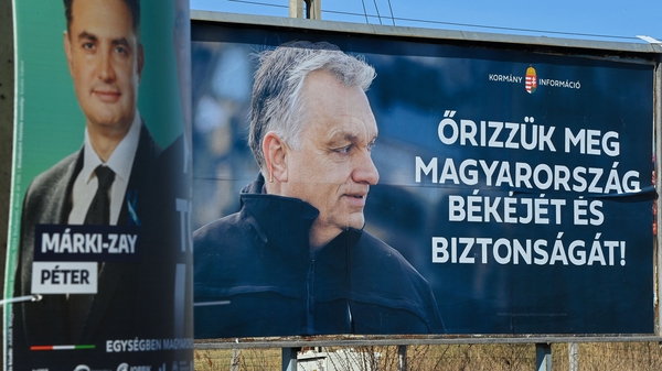 An election billboard of the Hungarian Prime Minister Viktor Orban, right, reads 'Save Hungary's peace and safety!' , with a smaller poster of Orban's opponent Peter Marki-Zay in Kisvarda, eastern Hungary