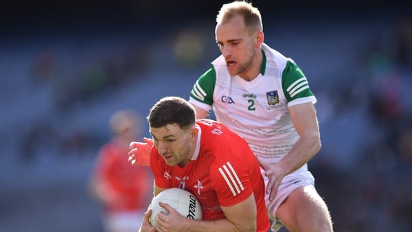 Sam Mulroy of Louth in action against Seán O'Dea of Limerick