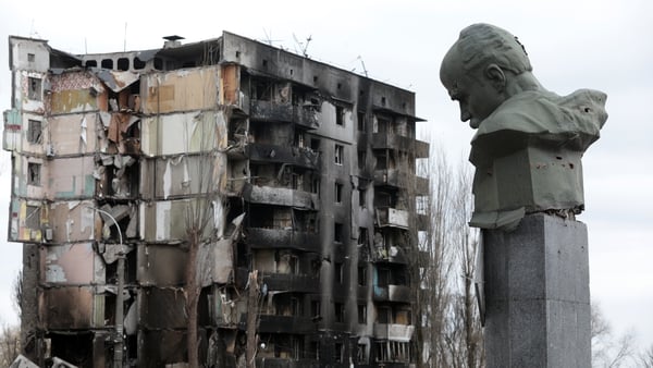 A monument to poet and Ukrainian nationalist Taras Shevchenko near a residential building destroyed by Russian shelling in Borodyanka, Kyiv Region