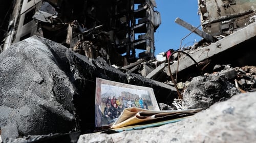 A group photo of Ukrainians is seen in the wreckage of a damaged residential building by the Russian air raids in Borodyanka
