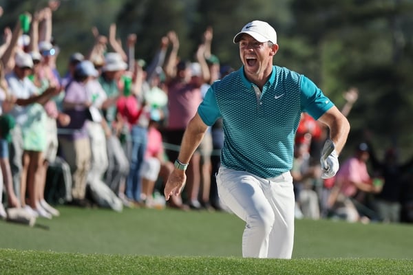 Rory McIlroy celebrates after his brilliant chip in from the bunker at the 18th hole