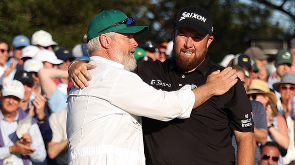 Lowry and caddie Bo Martin embrace after Lowry's closing birdie