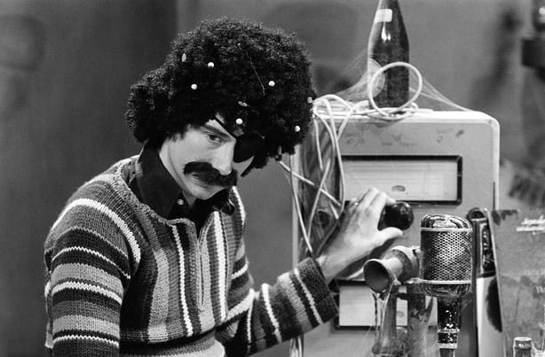 2280_091 September 1979 Vincent Hanley in 'Christmas at Castle Backtax' (1979) Vincent Hanley in a comedy sketch from RTÉ Television's 1979 Christmas Day variety show 'Christmas at Castle Backtax', during studio filming in September 1979. 'Christmas at Castle Backtax' included music and comedy sketches. The RTÉ Guide previewed the show on 21 December 1979. Photo by Joe St Leger