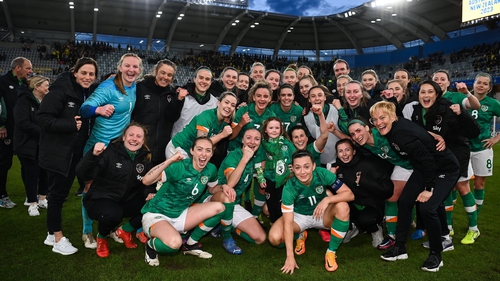 The Republic of Ireland squad celebrate with fan Annie Holland