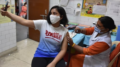 A health worker administers a dose of Corbevax Covid-19 vaccine during a vaccination drive 12-14 year olds in New Delhi