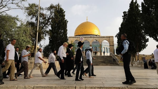 Jewish settlers escorted by Israeli forces enter the Al-Aqsa Mosque compound - known to Jews as the Temple Mount - after police drove out Palestinian worshippers this morning