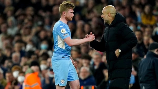 Kevin De Bruyne is congratulated by City manager Pep Guardiola after being substituted against Brighton