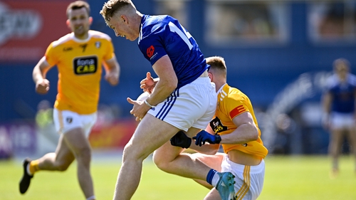 Cavan's Paddy Lynch is tackled by Peter Healy of Antrim