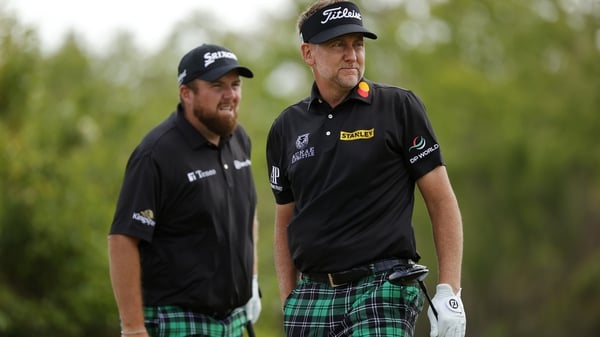 Shane Lowry (L) and Ian Poulter of England on the second tee