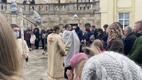 People congregated in St George's Cathedral in Lviv, their Easter baskets resting at their feet