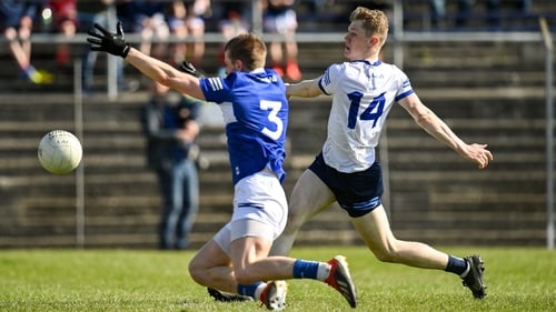 Kevin Quinn scores his third and Wicklow's fifth goal, despite pressure from Laois' Patrick O'Keane