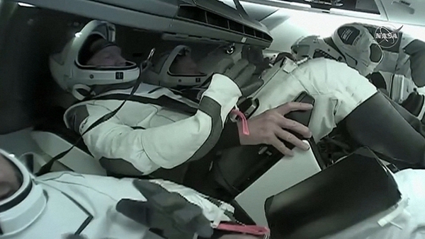 The Axiom astronauts, in their helmeted white-and-black spacesuits, strapped in and ready to return home