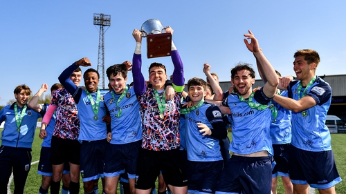 Lorcan Healy lifts the trophy with his UCD team-mates